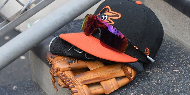 A Baltimore Orioles baseball hat and Oakley sunglasses sitting on the dugout steps during a game against the Detroit Tigers at Comerica Park May 15, 2022, in Detroit.
