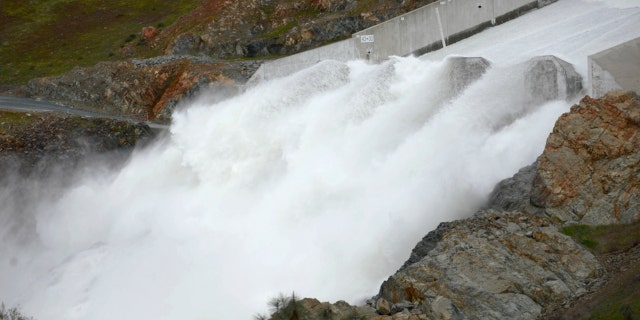 Water flows down Oroville Dam's main spillway in Oroville, Calif., Friday, March 10, 2023. Lake Oroville — one of the most important reservoirs in the state and home to the nation's tallest dam — has so much water that officials on Friday opened the dam's spillways for the first time since April 2019. The reservoir's water has risen 180 feet (54.8 meters) since Dec. 1. 