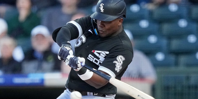 Oscar Colas #76 of the Chicago White Sox goes to ground in the first inning against the Kansas City Royals during a spring training game at Surprise Stadium on March 8, 2023 in Surprise, Arizona.