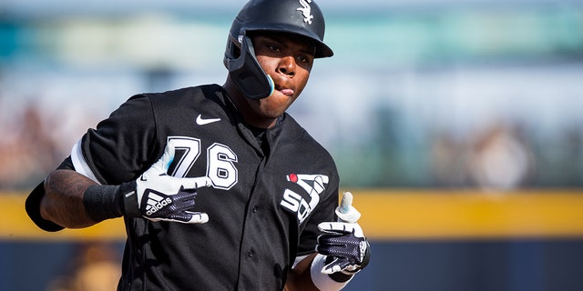 Oscar Colas #76 of the Chicago White Sox gestures as he rounds the bases after hitting a home run during the eighth inning of a Spring Training Game against the San Diego Padres at Peoria Stadium on March 11, 2023 in Peoria , Arizona.