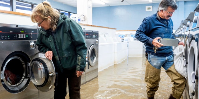 California slammed by heavy rain: Man zapped by downed wire, tree crashes into teen's room 2 Pamela and Patrick Cerruti empty coins from Pajaro Coin Laundry as floodwaters surround machines in the community of Pajaro in Monterey County, Calif., Tuesday, March 14, 2023. "We lost it all. That's half a million dollars of equipment," said Pamela who added that they plan to rebuild.