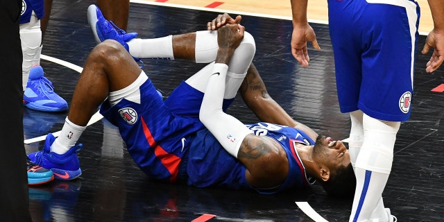 Paul George #13 of the Los Angeles Clippers suffers an apparent knee injury during a basketball game against the Oklahoma City Thunder at Crypto.com Arena on March 21, 2023 in Los Angeles, California.