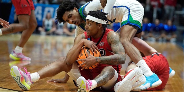 Southeast Missouri State's Phillip Russell grabs a loose ball against Texas A&amp;amp;M Corpus Christi's Simeon Fryer during the first half of a First Four college basketball game in the NCAA men's basketball tournament, Tuesday, March 14, 2023, in Dayton, Ohio. 