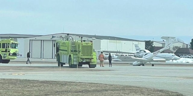 Emergency personnel responded after Taylor Hash safely landed the single-engine plane at Oakland County International Airport in Waterford, Michigan.