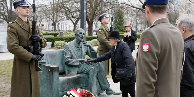 Members of a foundation supporting Poles who saved Jews from the Holocaust honor resistance emissary Jan Karski, who informed western leaders about mass killings of Jews by Nazi Germans, during national day of remembrance of Poles who risked their lives to save Jews, in Warsaw, Poland, on March 24, 2023.