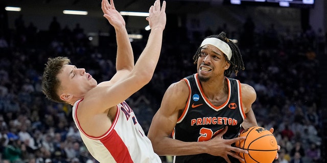 Tosan Evbuomwan #20 of the Princeton Tigers fouls Pelle Larsson #3 of the Arizona Wildcats during the second half in the first round of the NCAA Men's Basketball Tournament at Golden 1 Center on March 16, 2023 in Sacramento, California.