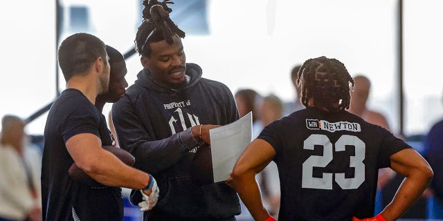 Former NFL and Auburn quarterback Cam Newton speaks to receivers during Auburn Pro Day, Tuesday, March 21, 2023, in Auburn, Alabama. 