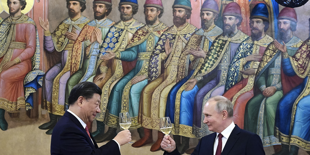 Russian President Vladimir Putin and Chinese President Xi Jinping toast during their dinner in Moscow on March 21.