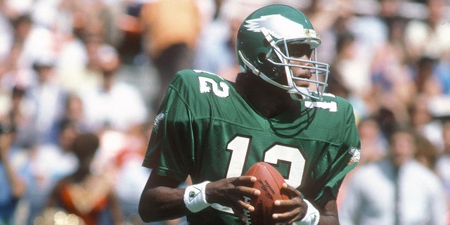 Philadelphia Eagles number 12 Randall Cunningham drops back to pass against the Washington Redskins during an NFL football game September 7, 1986 at RFK Stadium in Washington, DC Cunningham played for the Eagles from 1985 to 1995.