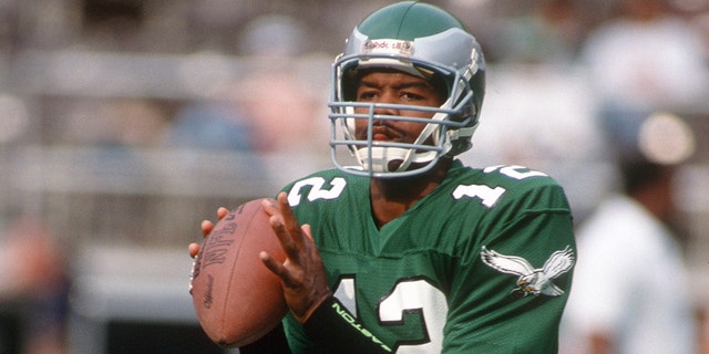Philadelphia Eagles number 12 Randall Cunningham looks to pass during a circa 1990 NFL football game at Veterans Stadium in Philadelphia.  Cunningham played for the Eagles from 1985 to 1995.