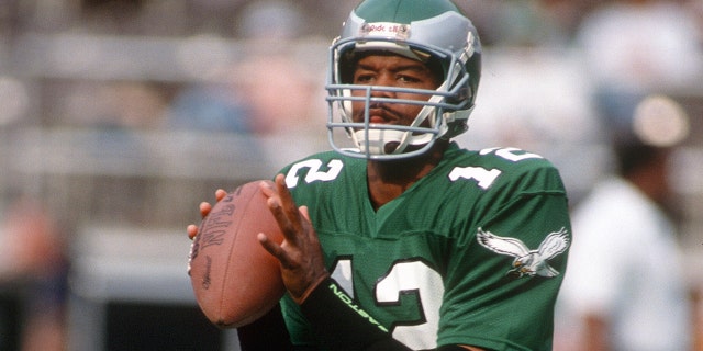 Randall Cunningham, #12 of the Philadelphia Eagles, looks to pass during an NFL Football game circa 1990 at Veterans Stadium in Philadelphia. Cunningham played for the Eagles from 1985-1995.