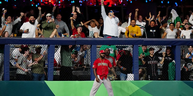 Randy Aroza of Team Mexico #56 reacts by stealing a solo home run off Kazuma Okamoto of Team Japan #25 during the 2023 World Baseball Classic Semifinal game Monday, March 20, 2023, in Miami, Florida.