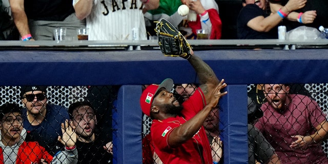 Randy Arozarena #56 of Team Mexico makes a leaping catch against the wall for the final out of the bottom of the fifth inning during the 2023 World Baseball Classic Semifinal game between Team Mexico and Team Japan at loanDepot Park on Monday, March 20, 2023, in Miami, Florida.