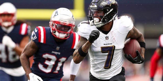 Wide receiver Rashod Bateman, #7 of the Baltimore Ravens, runs upfield while cornerback Jonathan Jones, #31 of the New England Patriots, pursues during the fourth quarter at Gillette Stadium on Sept. 25, 2022 in Foxborough, Massachusetts.