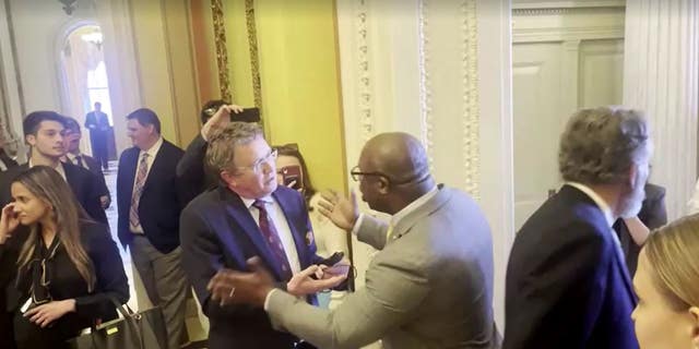 Reps. Thomas Massie, left, and Jamaal Bowman get into a shouting match over gun control legislation while pacing the halls of Congress on Wednesday.