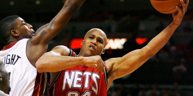 Heat's Dorell Wright attempts to block New Jersey Nets' Richard Jefferson in Miami on Dec. 20, 2007.