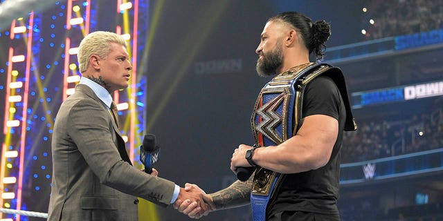 Cody Rhodes, left, and Roman Reigns meet in the center of the ring during an installment of WWE Smackdown in Washington, D.C., on March 3, 2023.