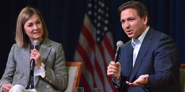 Florida Gov. Ron DeSantis, right, speaks at a campaign event with Iowa Gov. Kim Reynolds on Friday, March 10, 2023, in Davenport, Iowa.