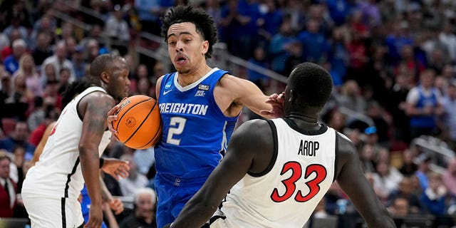 Creighton guard Ryan Nembhard (2) runs into San Diego State forward Aguek Arop (33) in the first half of a Elite 8 college basketball game in the South Regional of the NCAA Tournament, Sunday, March 26, 2023, in Louisville, Ky.