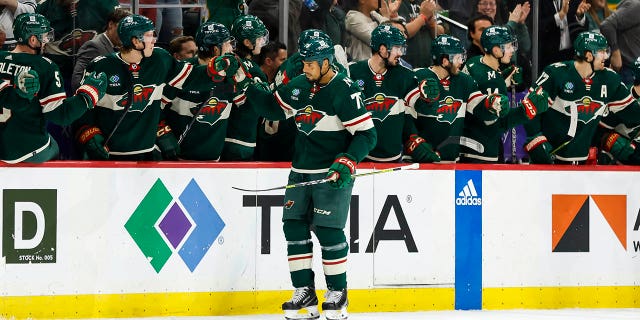 Ryan Reaves #75 de Minnesota Wild patina cerca del banco Wild y celebra su gol con sus compañeros en el segundo tiempo del partido contra Chicago Blackhawks en Xcel Energy Center el 25 de marzo de 2023 en St Paul, Minnesota.