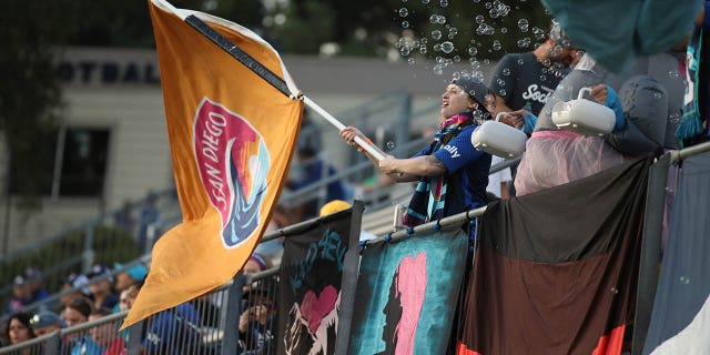 A fan holds a Wave FC flag prior to the match against Orlando Pride at Torero Stadium on Aug. 13, 2022 in San Diego, California.