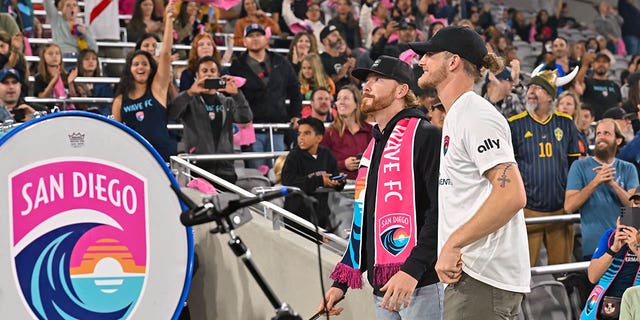 Padres Steven Wilson and Josh Hader beat the Wave FC drum before a match against the Chicago Red Stars on Oct. 16, 2022, at Snapdragon Stadium in San Diego.