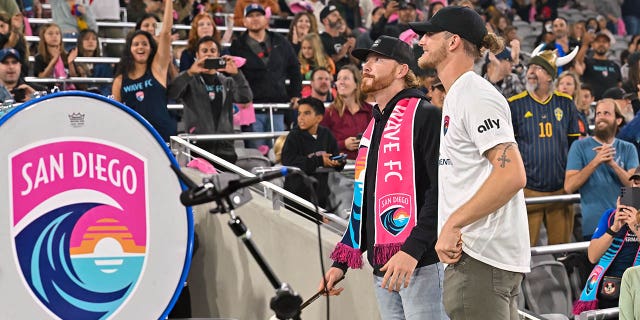 Padres Steven Wilson and Josh Hader beat the Wave FC drum before a match against the Chicago Red Stars on Oct. 16, 2022, at Snapdragon Stadium in San Diego.