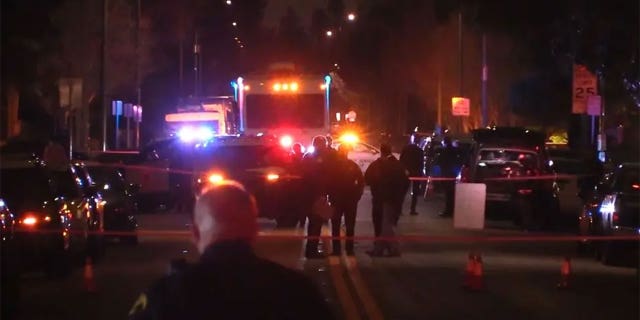 Police securing the perimeter of a house in which a man with a machete held three hostages in San Jose, California.