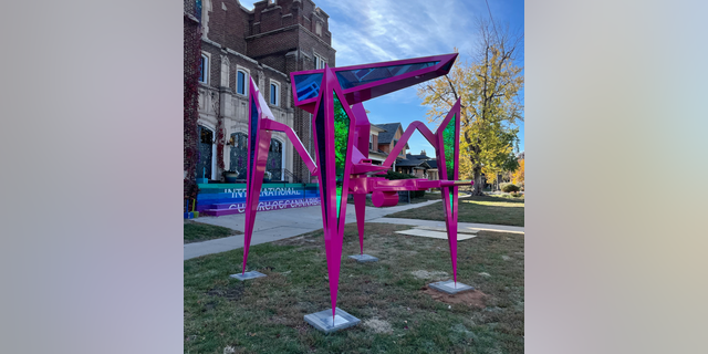 A pink sculpture titled Public Defender stands outside the International Church of Cannabis