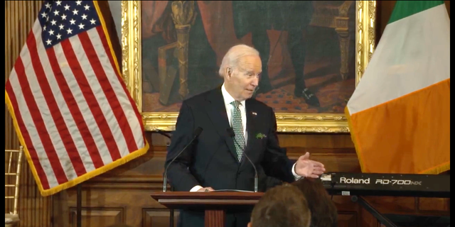 President Biden in front of American and Irish flags