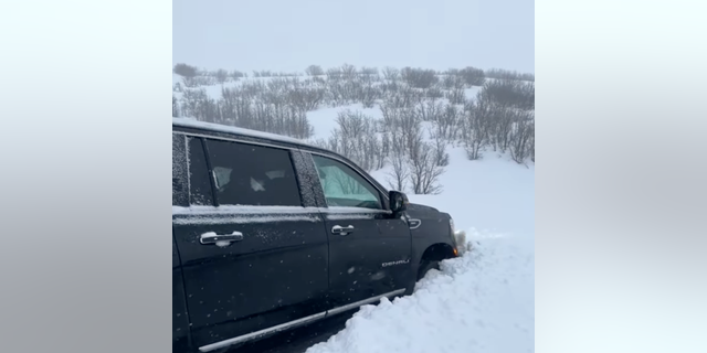 Meredith Marks posted a video of a vehicle completely stuck in a massive snow pile. The wheel was covered in snow as the car emergency lights appeared to be flashing.