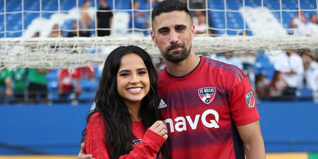 Singer Becky G and her now-fiance Sebastian Lletget #12 of FC Dallas pose for picture after the game between FC Dallas and Sporting Kansas City at Toyota Stadium on October 9, 2022 in Frisco, Texas.