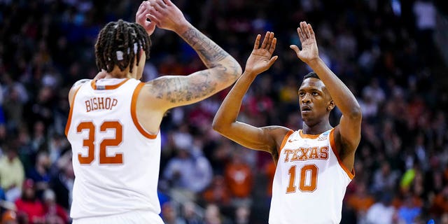 Mar 26, 2023; Kansas City, MO, USA;  Texas Longhorns forward Christian Bishop (32) high-fives guard Sir'Jabari Rice (10) during a stop in play against the Miami Hurricanes in the first half at the T-Mobile Center.