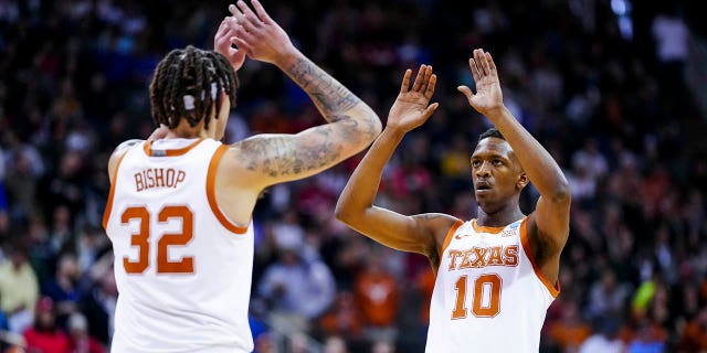 Mar 26, 2023; Kansas City, MO, USA; Texas Longhorns forward Christian Bishop (32) high-fives guard Sir'Jabari Rice (10) during a stop in play against the Miami Hurricanes in the first half at the T-Mobile Center.