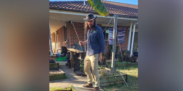 Snake catcher Kane Durrant stands by a pile of hatched eastern brown snake eggs at a home in Sydney, Australia.