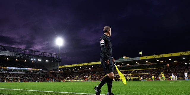 A general view of the assistant referee running the line at Carrow Road Stadium home of Norwich City during the Premier League match between Norwich City and Wolverhampton Wanderers at Carrow Road on November 27, 2021 in Norwich, England.