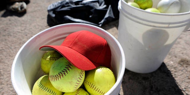 A view of softballs in a bucket.