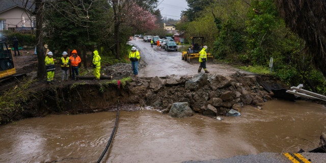 Crews assess storm damage, which washed out North Main Street in Soquel, Calif., Friday, March 10, 2023.