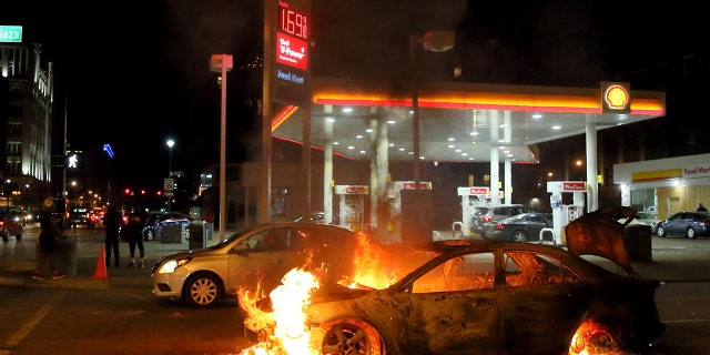 A car burns at the corner of Martin Luther King Boulevard and Tucker Boulevard on Tuesday, June 2, 2020.