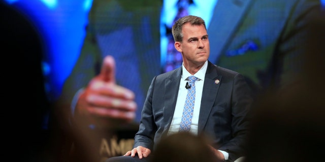 Kevin Stitt, governor of Oklahoma, listens during the Conservative Political Action Conference in Dallas, Texas, July 10, 2021.