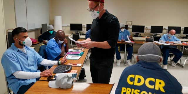 Instructor Douglas Arnwine returns papers with comments to his incarcerated students during a Mount Tamalpais College English class called Cosmopolitan Fictions at San Quentin State Prison on April 12, 2022 in San Quentin, California. 
