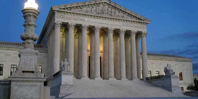 Light illuminates part of the Supreme Court building at dusk on Capitol Hill in Washington on November 16, 2022.