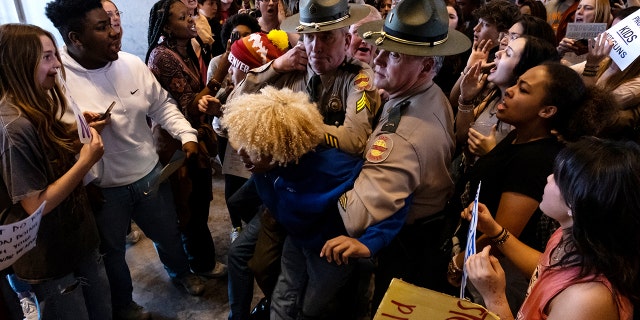 Chants of "no justice, no peace" and "save our children" echoed through the Tennessee House of Representatives chamber as pro-gun control protesters posted up both inside and outside the state capitol building.