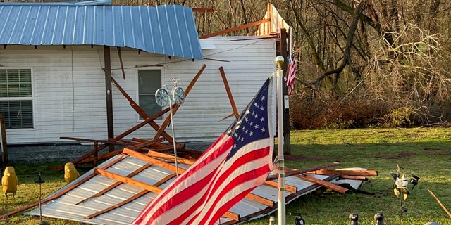 An American flag in storm wreckage in a front yard in Tennessee