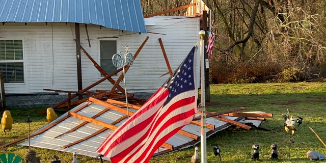 An American flag in storm wreckage in a front yard in Tennessee