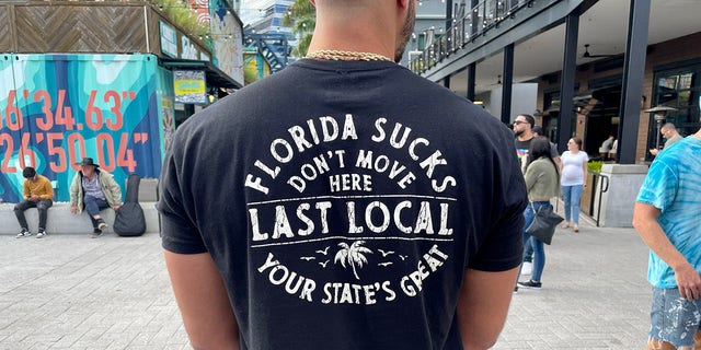 A man at Sparkman Wharf in Tampa wears his fears of Florida losing its freedoms as newcomers flood the state. "Don't move here. Your state's great."