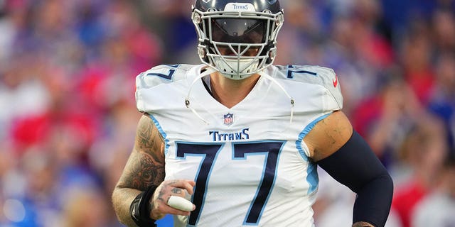 Taylor Lewan, #77 of the Tennessee Titans, runs onto the field against the Buffalo Bills at Highmark Stadium on Sept. 19, 2022 in Orchard Park, New York.