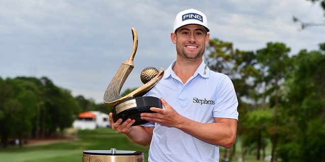 Taylor Moore of the United States celebrates with the trophy after winning during the final round of the Valspar Championship at Innisbrook Resort and Golf Club on March 19, 2023 in Palm Harbor, Florida.