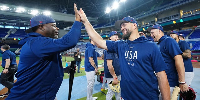 Hitting coach Ken Griffey Jr., #24, celebrates with Team USA's Kyle Schwarber, #12, after batting practice during Team USA's workout prior to the quarterfinal game of the 2023 World Baseball Classic between Team Puerto Rico and Team Mexico at LoanDepot Park on Friday, March 17, 2023, in Miami, Florida.