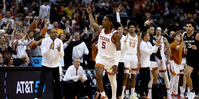 Marcus Carr, #5 of the Texas Longhorns, reacts after scoring a three-point basket against the Xavier Musketeers during the second half in the Sweet 16 round of the NCAA Men's Basketball Tournament at T-Mobile Center on March 24, 2023, in Kansas City, Missouri.